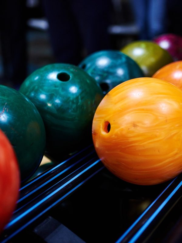 Stand with colorful bowling balls in club